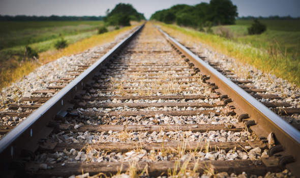 Train tracks and green pasture